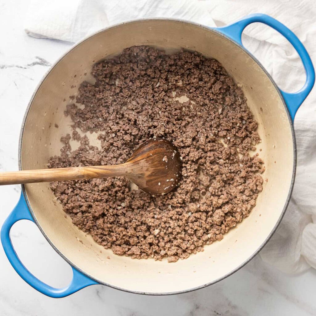 Ground beef cooked in pot.