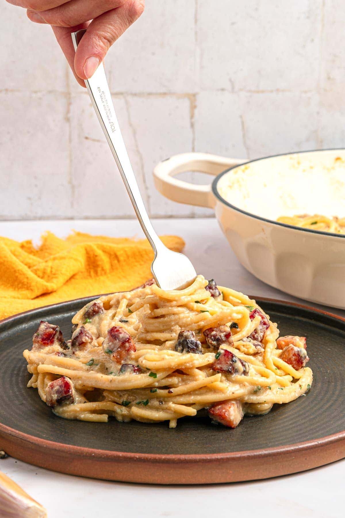 Carbonara Recipe twirled on fork.