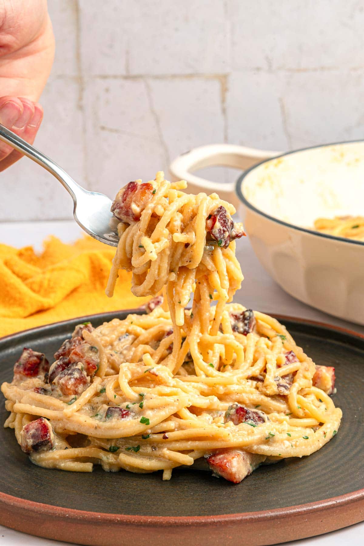 Carbonara Recipe lifted with fork.