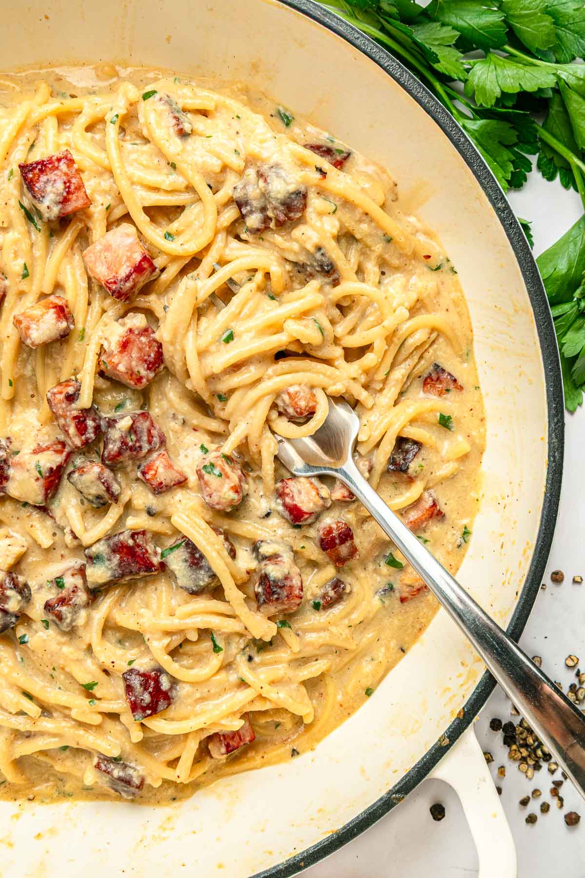 Carbonara Recipe in pan with fork in pasta.