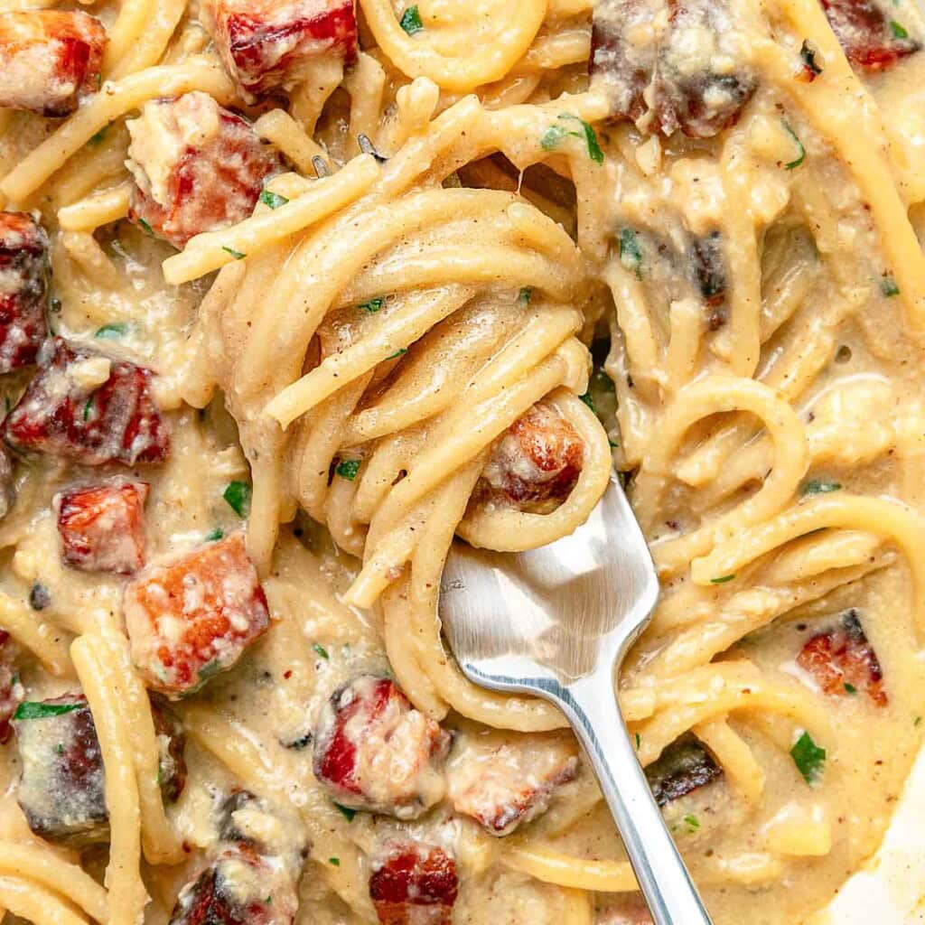 Carbonara Recipe close-up of pasta on fork.