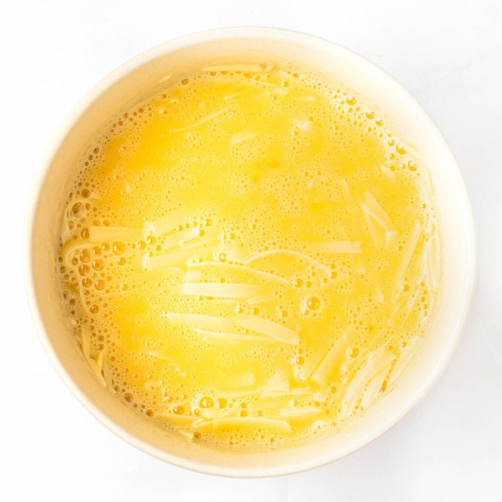Beaten eggs mixed with grated Parmesan.