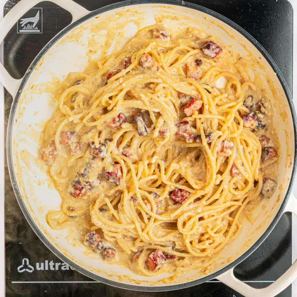 Egg mixture and pasta water mixed in to make sauce.
