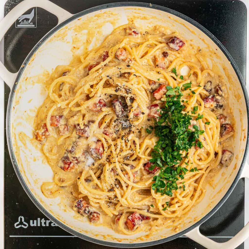 Adding parsley and seasonings to Carbonara Recipe.