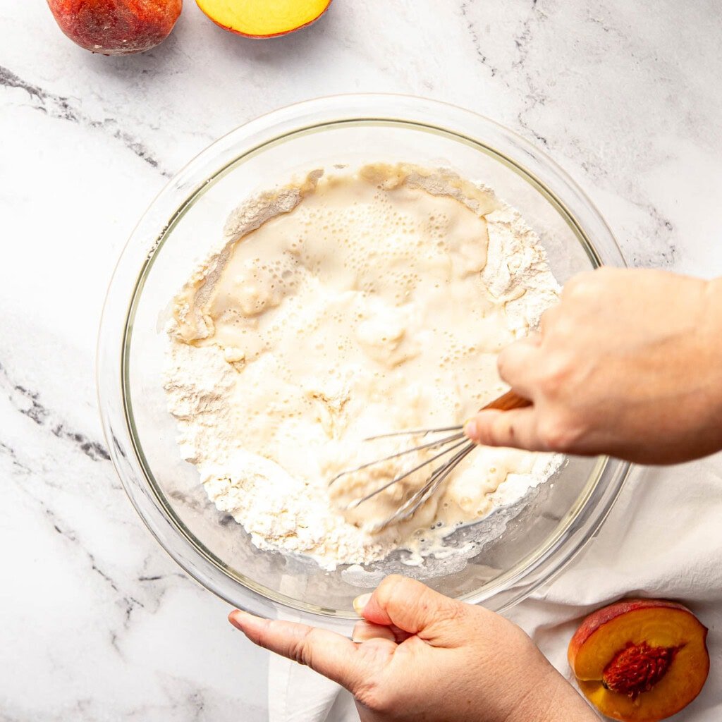Whisking batter for peach cobbler recipe easy.