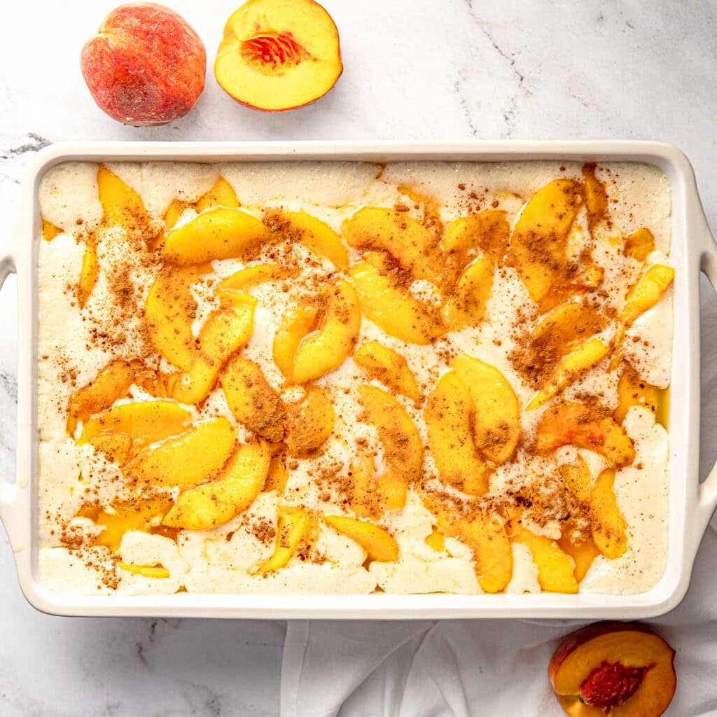 Easy Peach Cobbler recipe in baking dish ready for the oven.