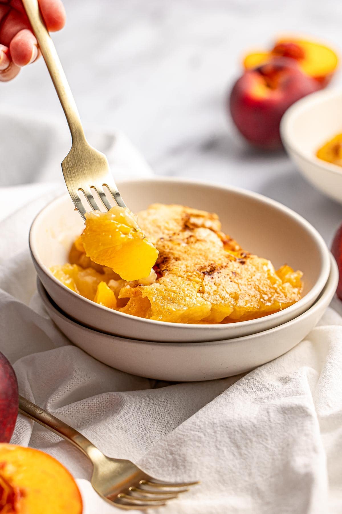 Easy Peach Cobbler with bite on fork.