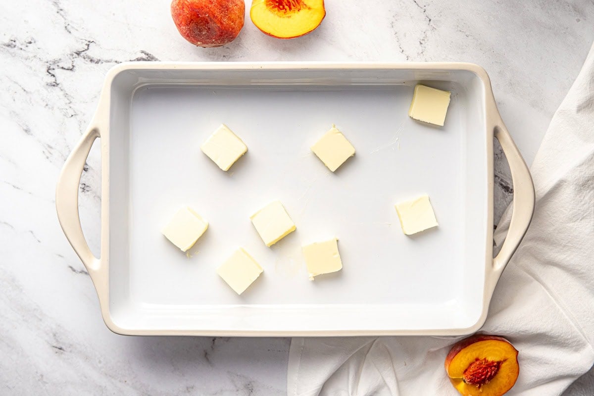 Slices of butter in baking dish.