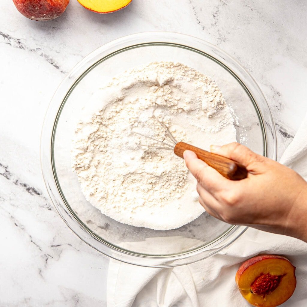 Whisking together dry ingredients in bowl.