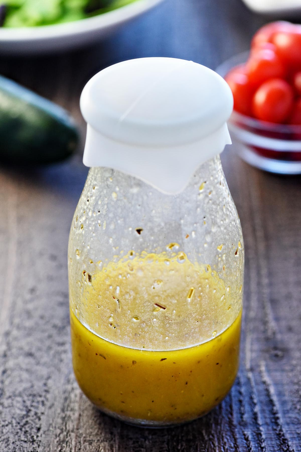 Greek Salad Dressing in glass jar with silicone lid.