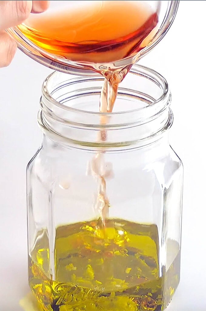 Adding vinegar to Greek Dressing Recipe.