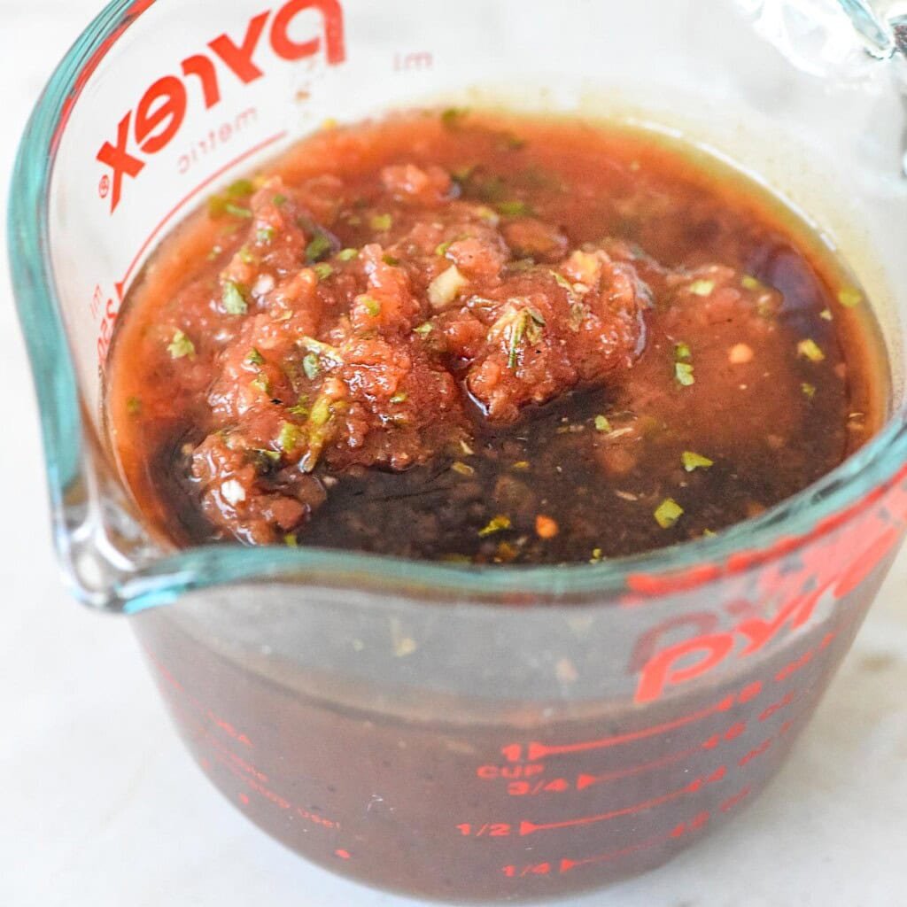 BBQ sauce and salsa in measuring cup.