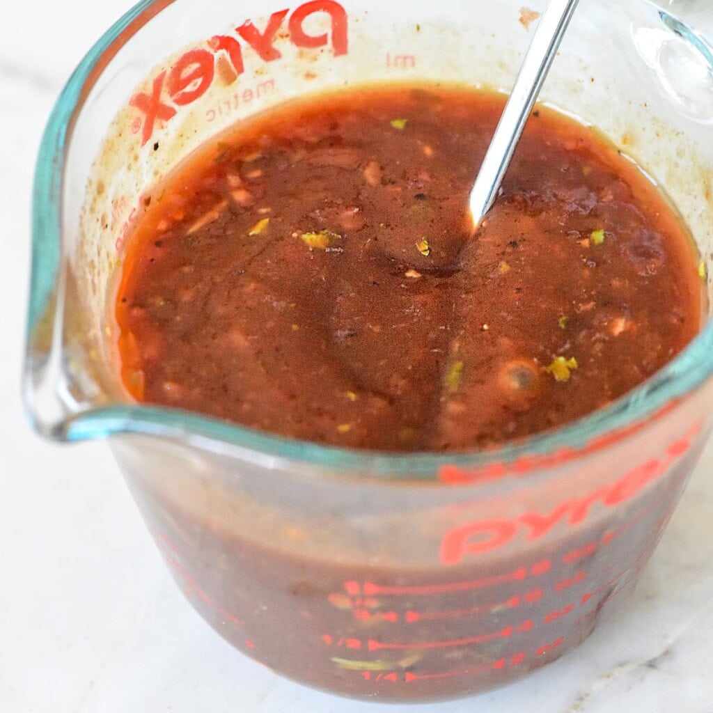 BBQ glaze for mini meatloaf recipe in measuring cup.