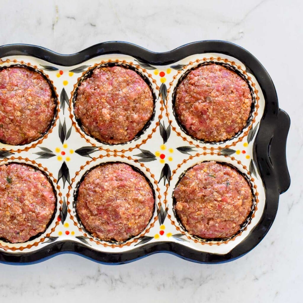 Meatloaf Muffins uncooked in muffin pan.