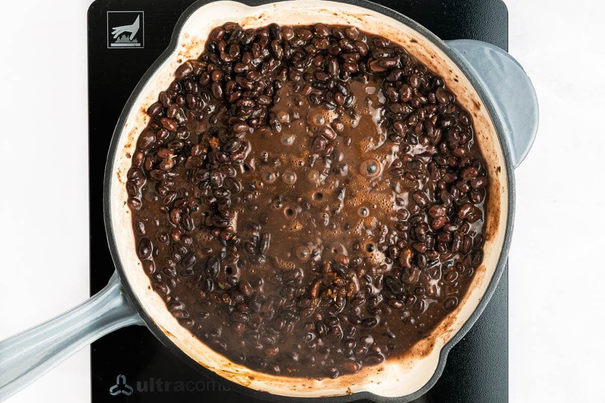 Seasoned Black Beans simmering on stove.