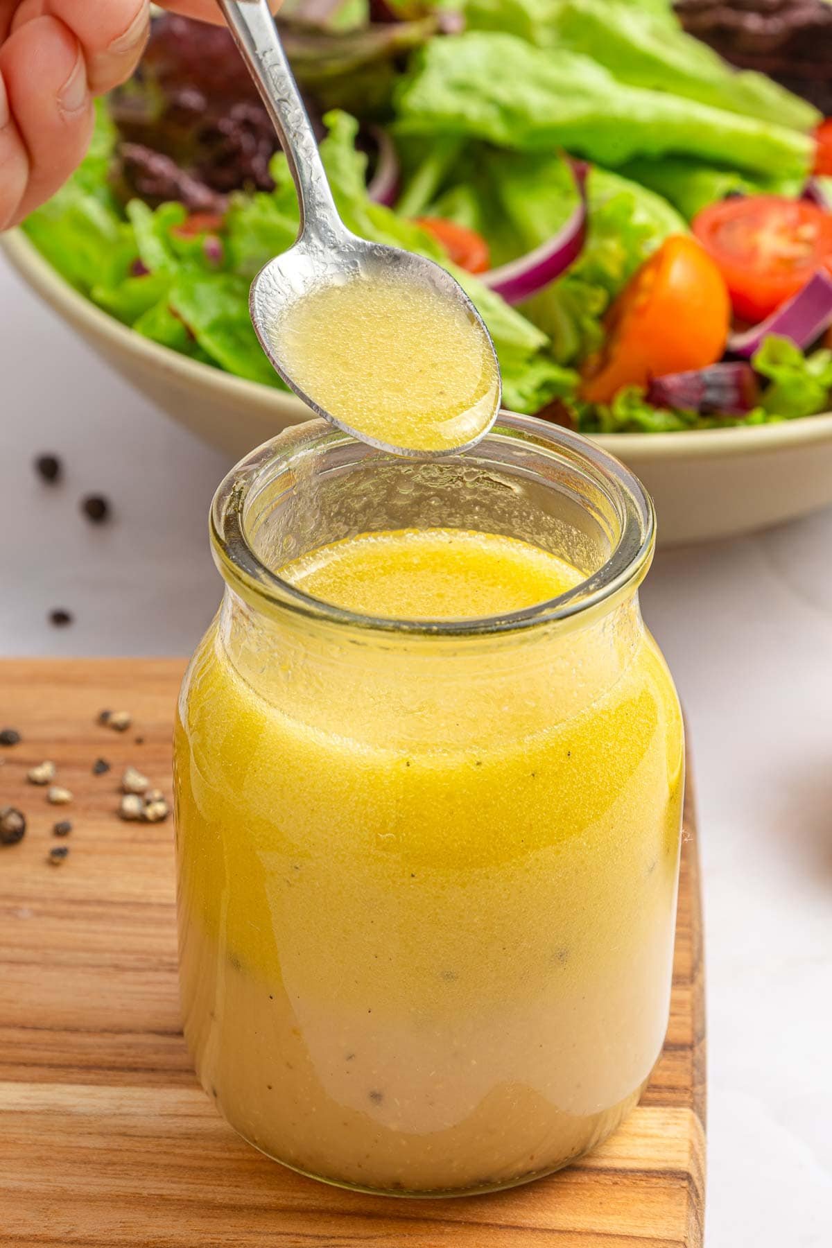 White balsamic dressing on spoon.