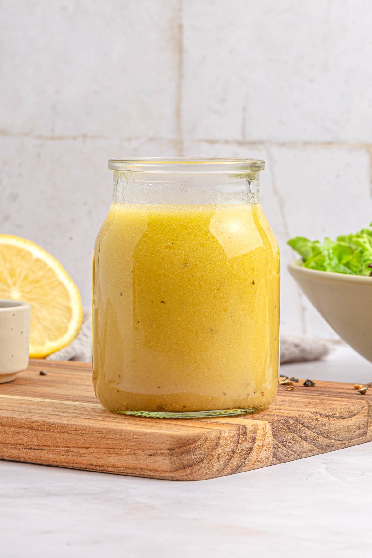 White balsamic dressing in jar, side view.