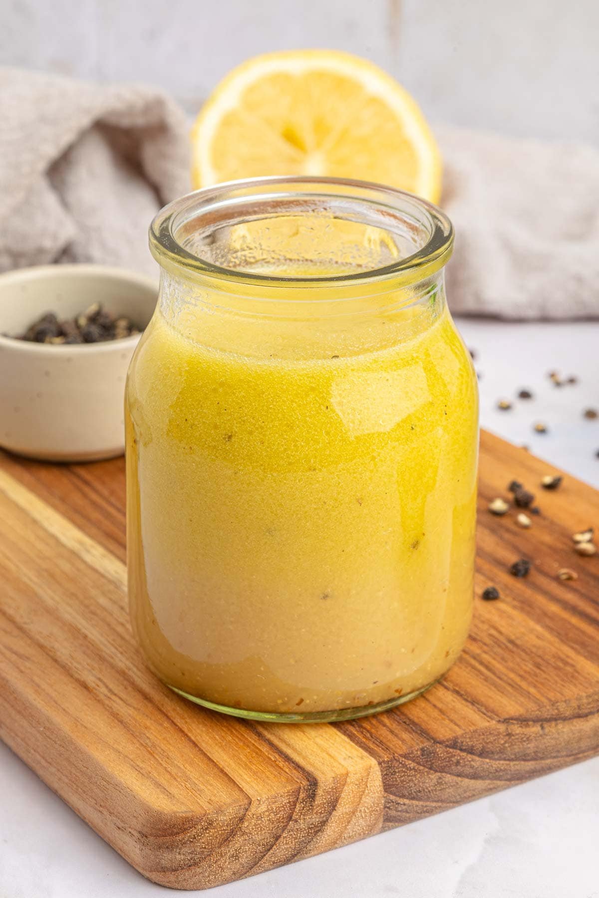 Vinaigrette with white balsamic vinegar close-up in jar.