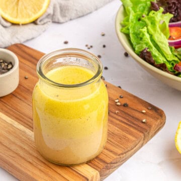 White Balsamic Vinaigrette in jar with ingredients on table.