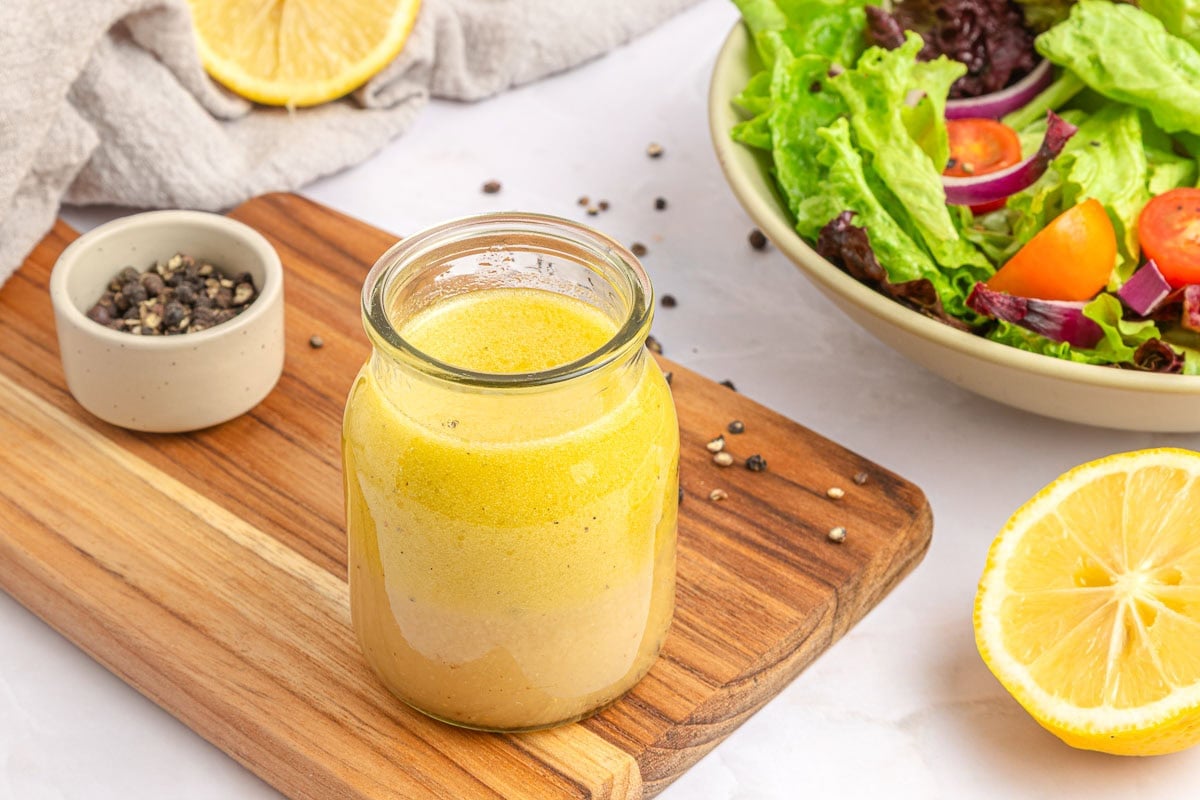 White Balsamic Vinaigrette in jar with ingredients on table.