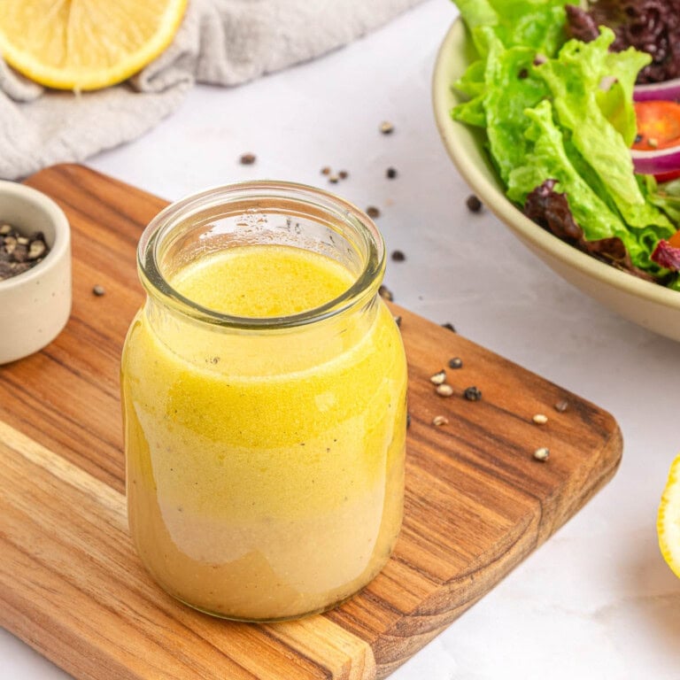 White Balsamic Vinaigrette in glass jar with salad.