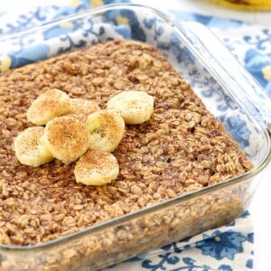 Banana Baked Oatmeal in dish with garnish of sliced bananas and cinnamon.