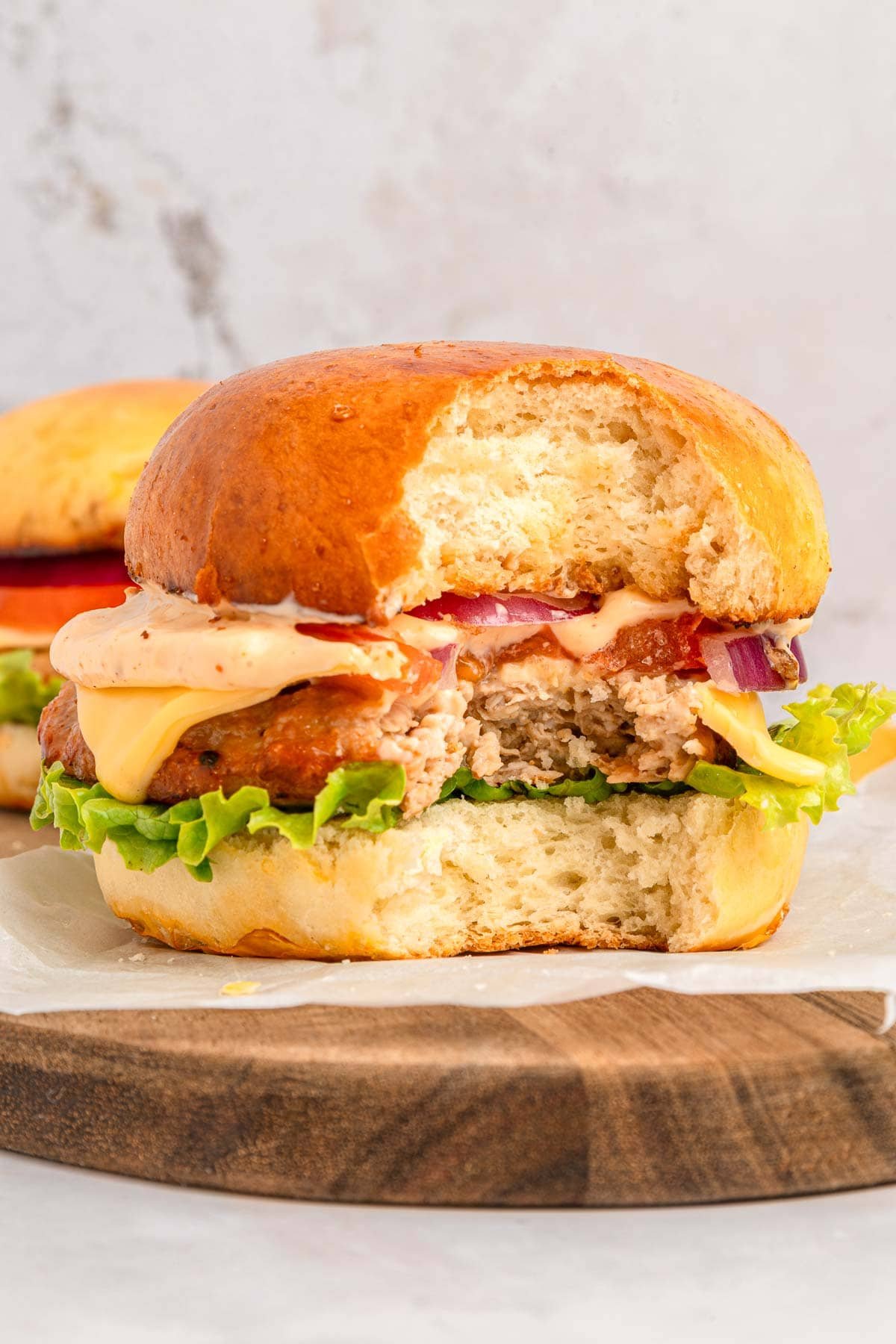 Chicken Burger with missing bite.
