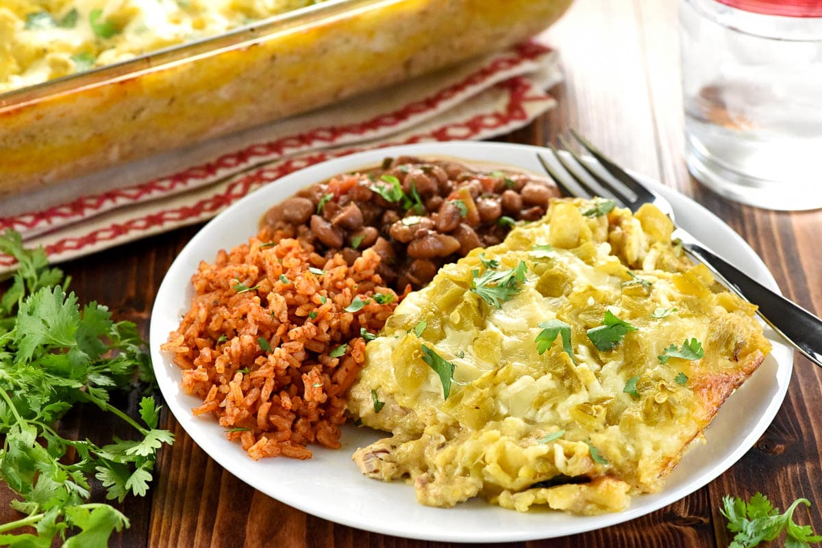 Chicken Enchilada Casserole with beans, Spanish rice, and cilantro.
