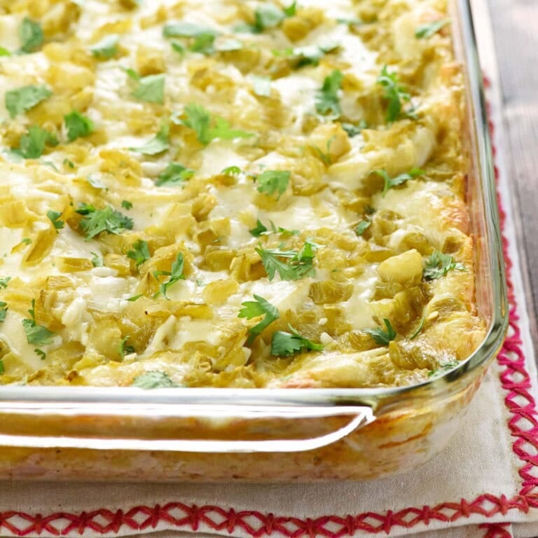 Chicken Enchilada Casserole in baking dish with cilantro garnish.