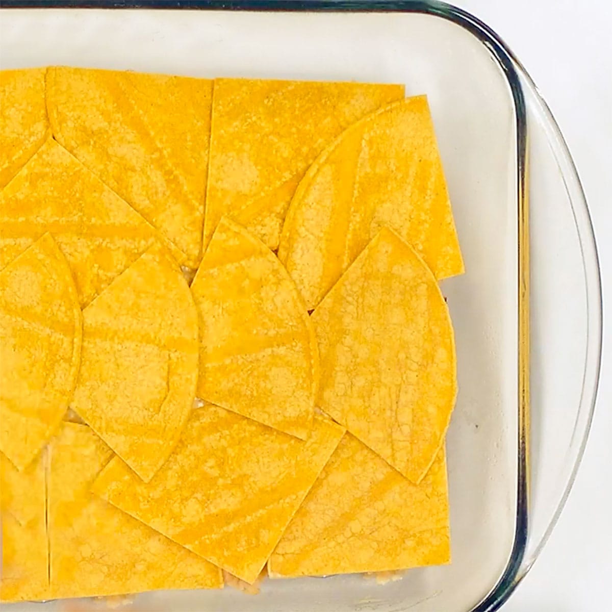 Adding layer of quartered corn tortillas to Chicken Enchilada Casserole recipe.