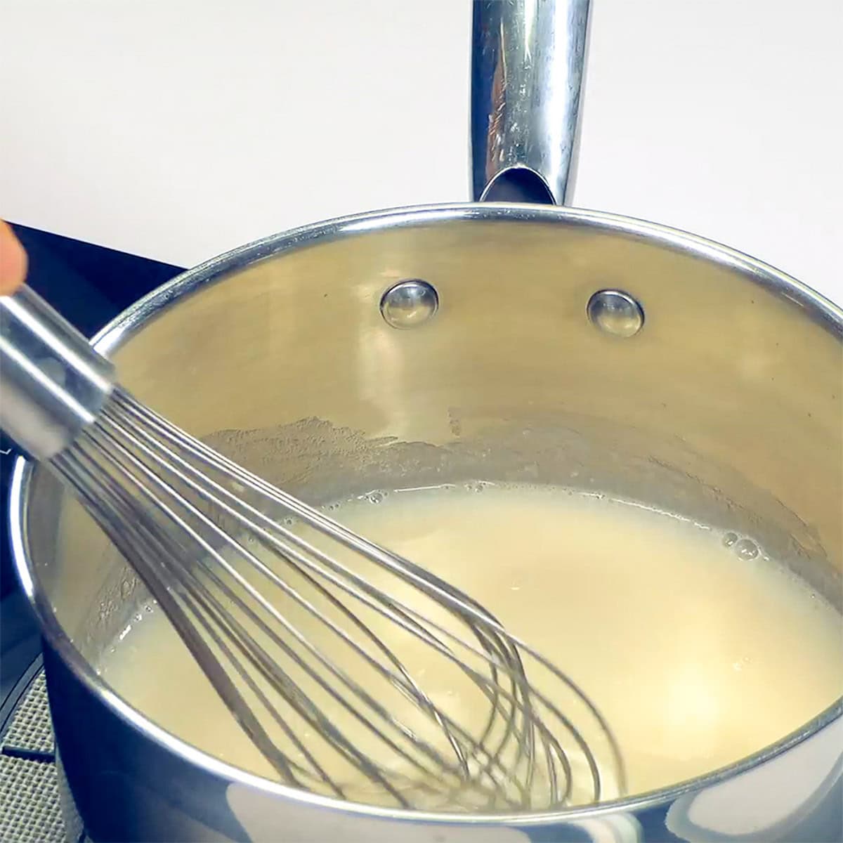 Whisking homemade sauce to go in Chicken Enchilada Casserole.
