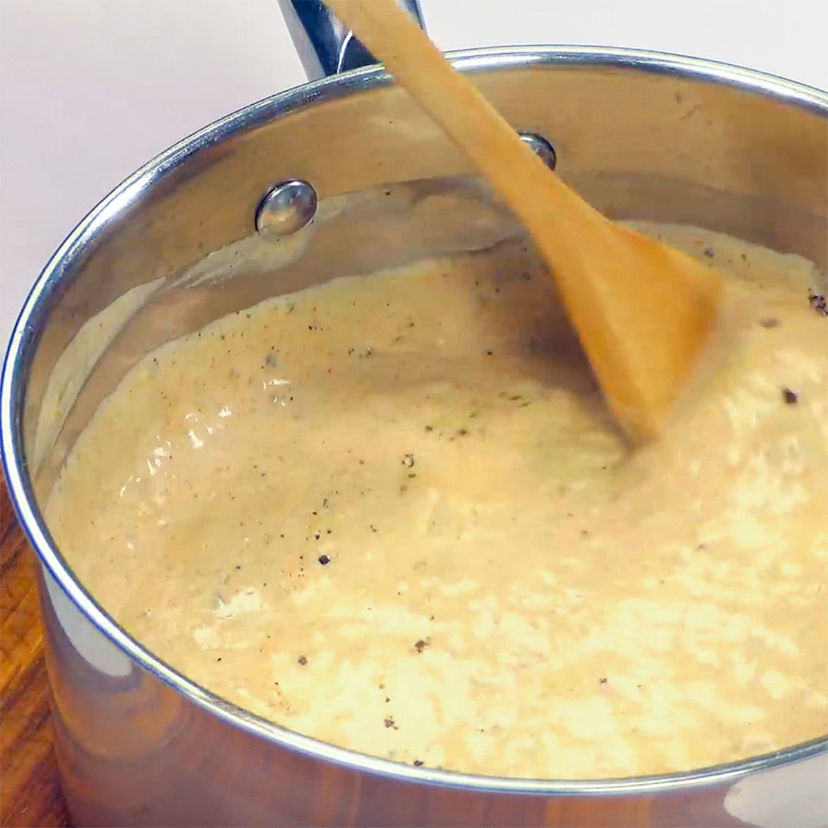 Chicken Enchilada Casserole sauce in pot.