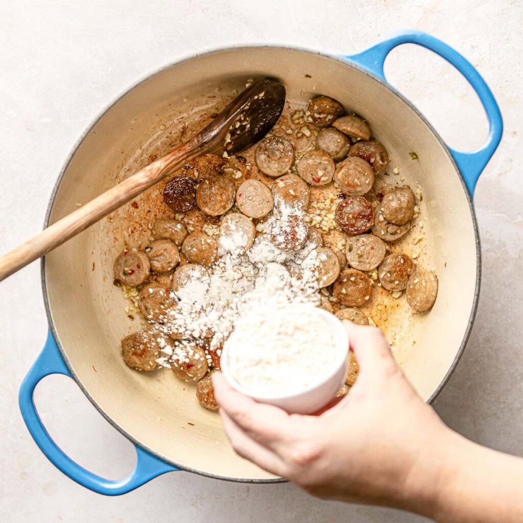 Sprinkling flour into pot.