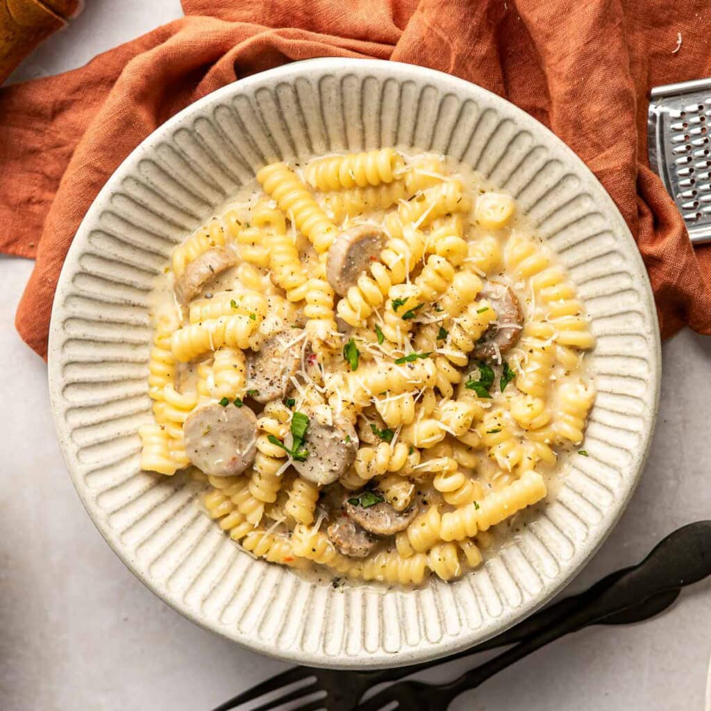 Chicken Sausage Pasta aerial view in bowl with garnishes.