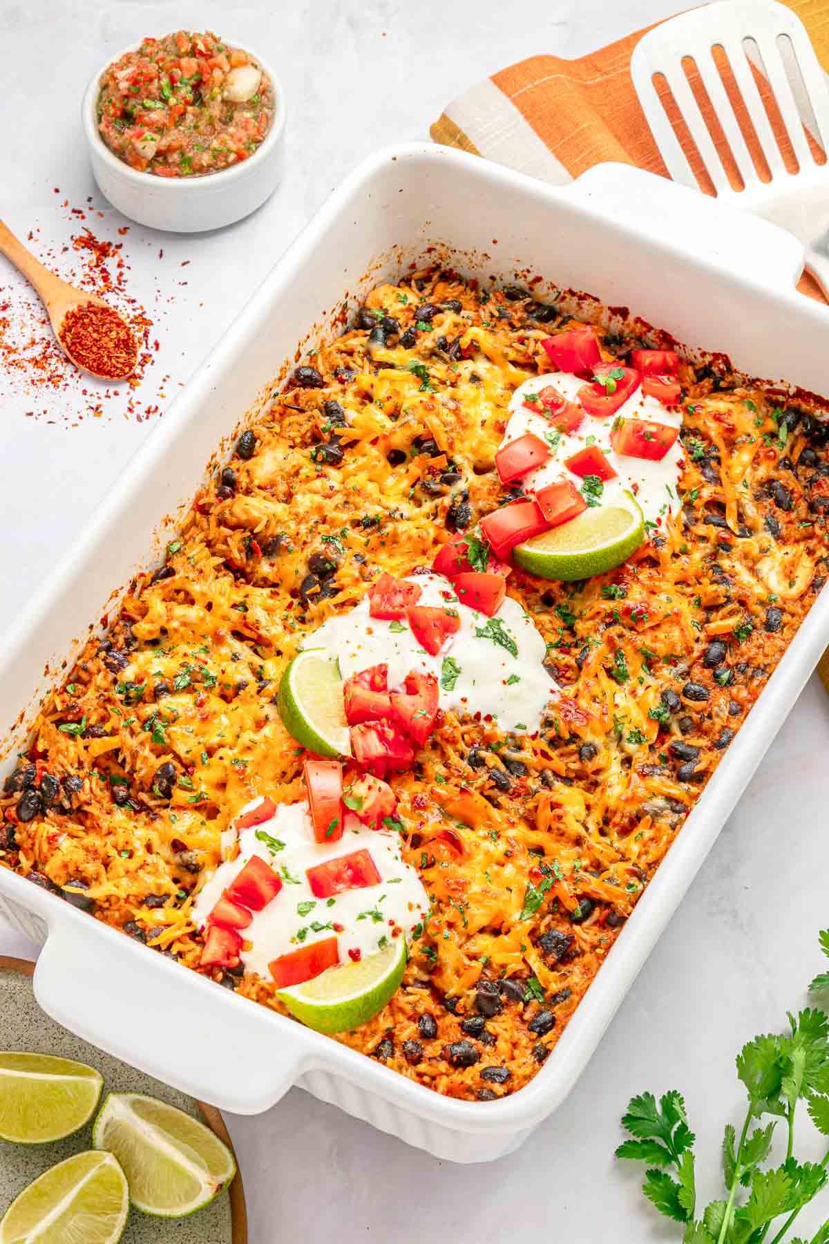 Mexican Chicken and Rice Casserole with limes for squeezing on top.