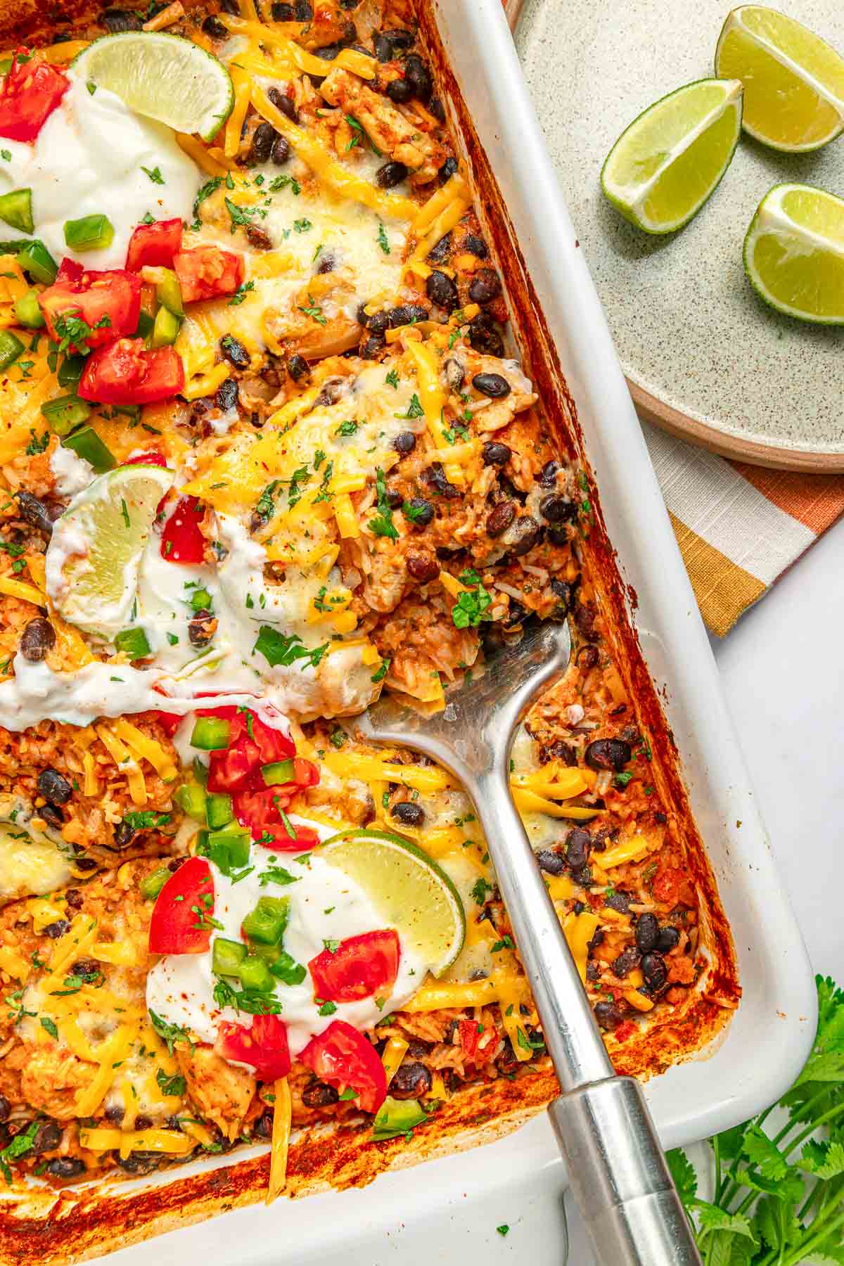Mexican Chicken and Rice Casserole with spatula removing a serving.