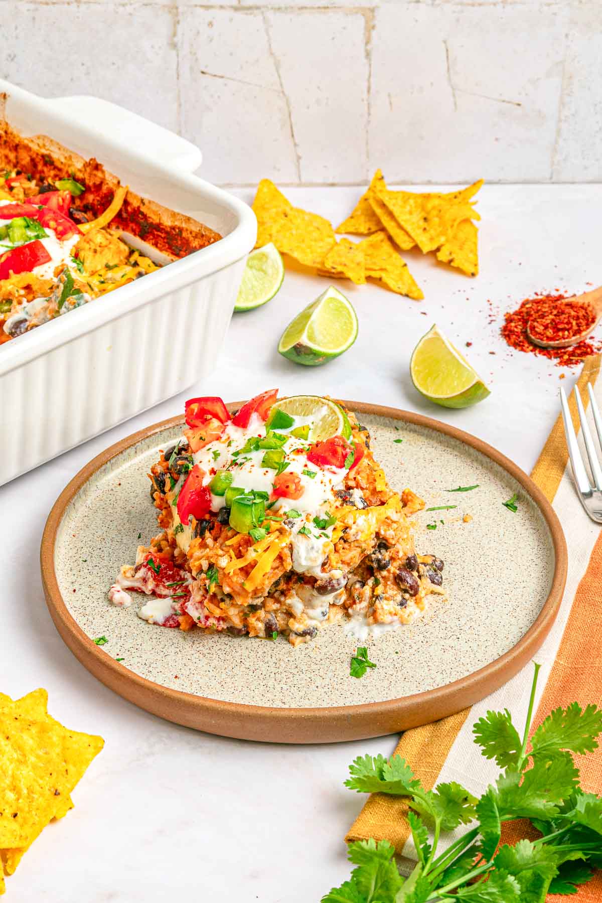 Mexican Chicken and Rice Casserole on plate with dish in background.