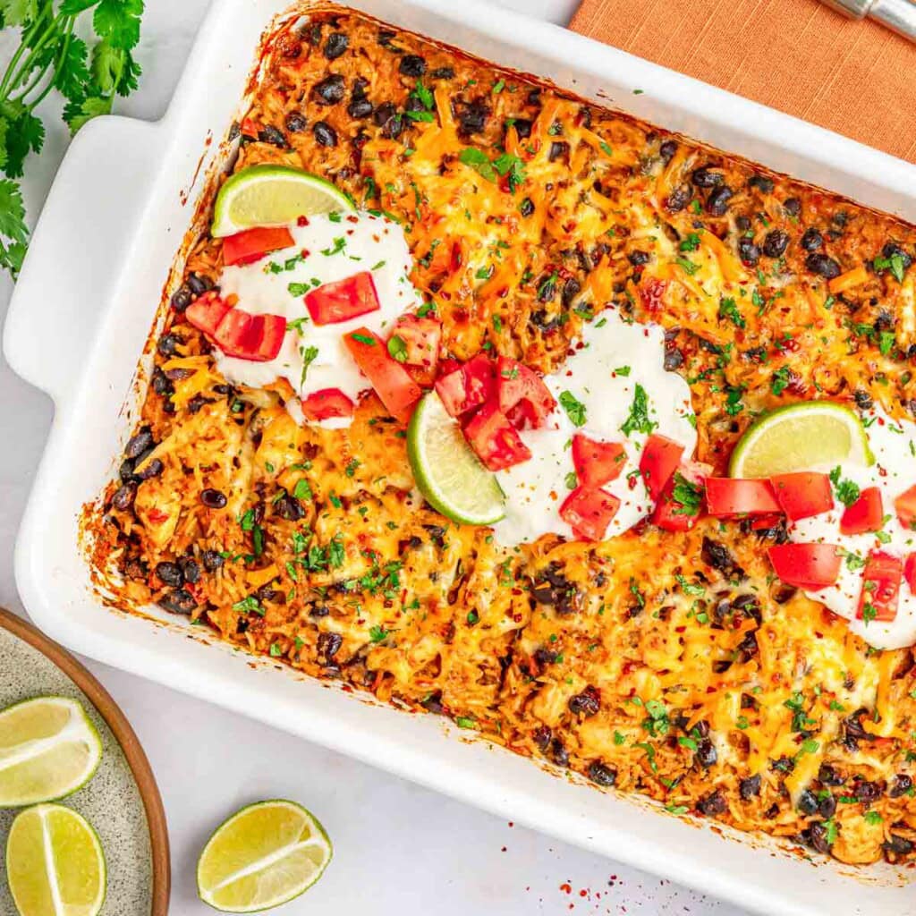 Mexican Chicken and Rice Casserole aerial close-up in baking dish with garnishes.