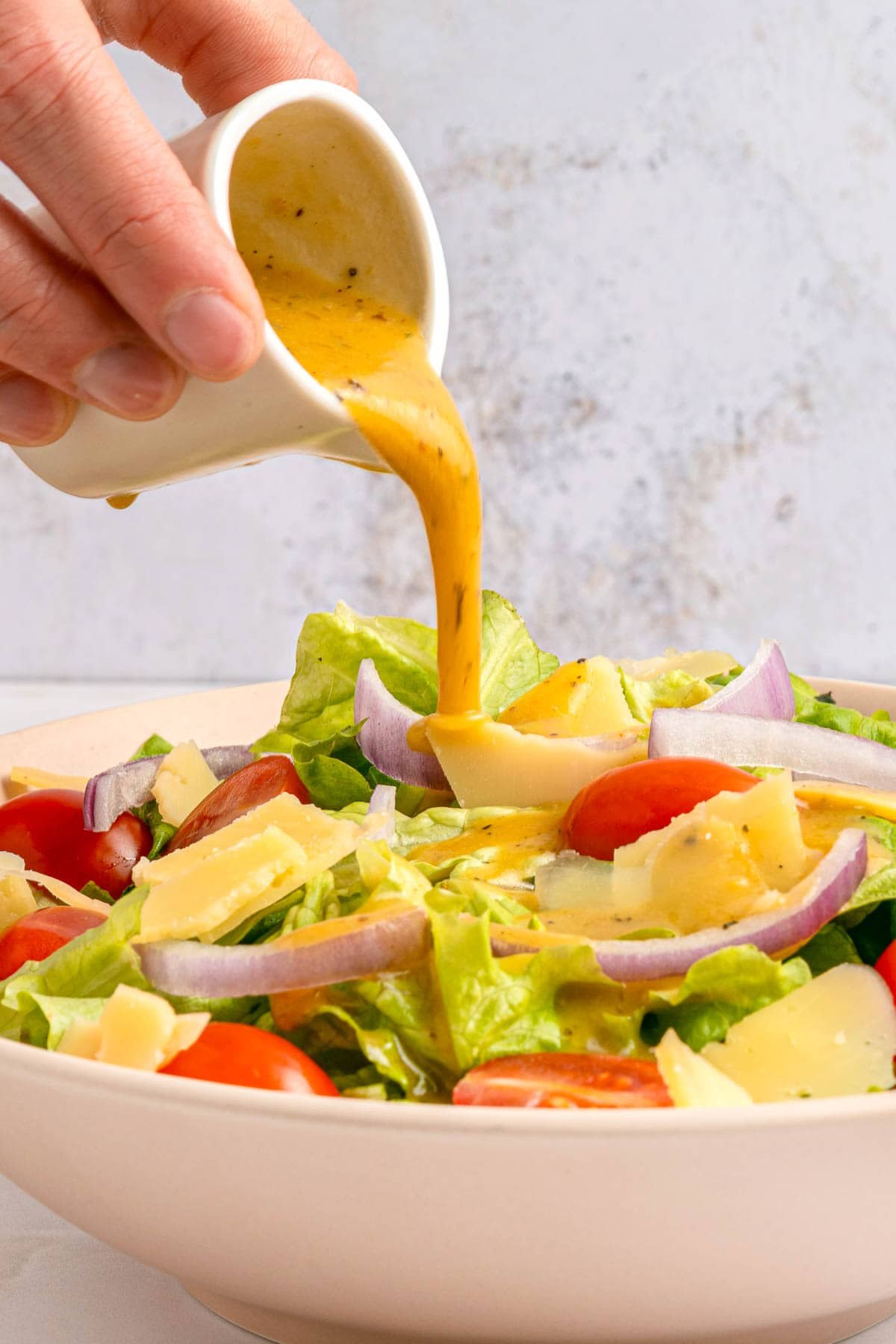 Red Wine Vinaigrette pouring over salad close-up.