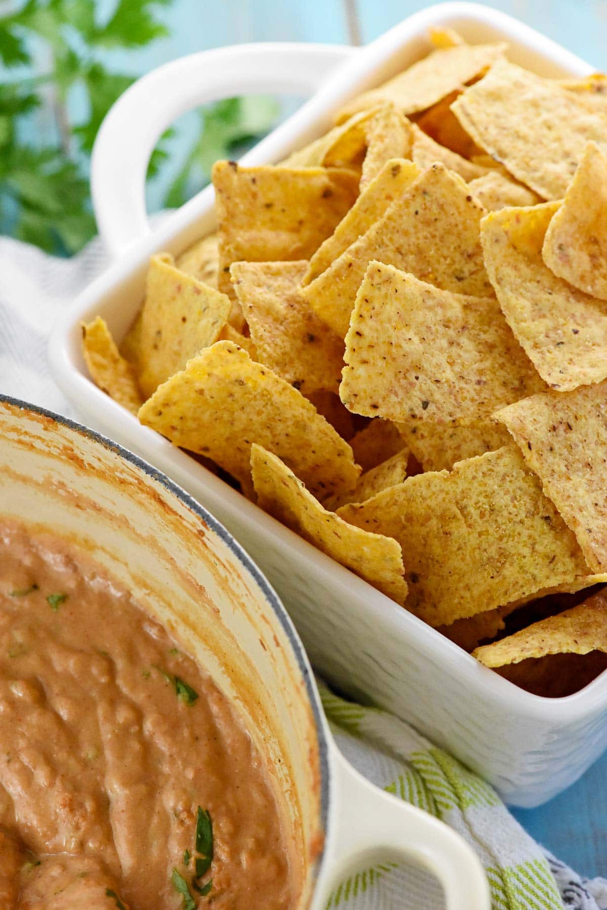 Bean Dip with refried beans next to bowl of chips.