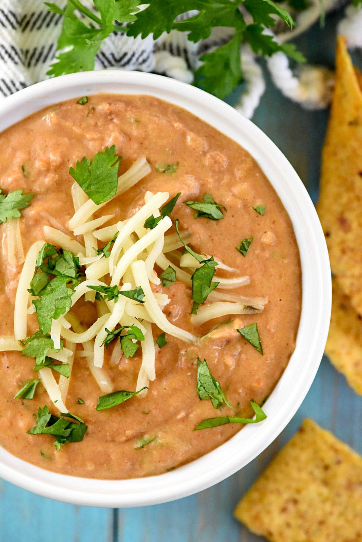 Bean Dip recipe aerial view with garnish of cilantro and cheese.