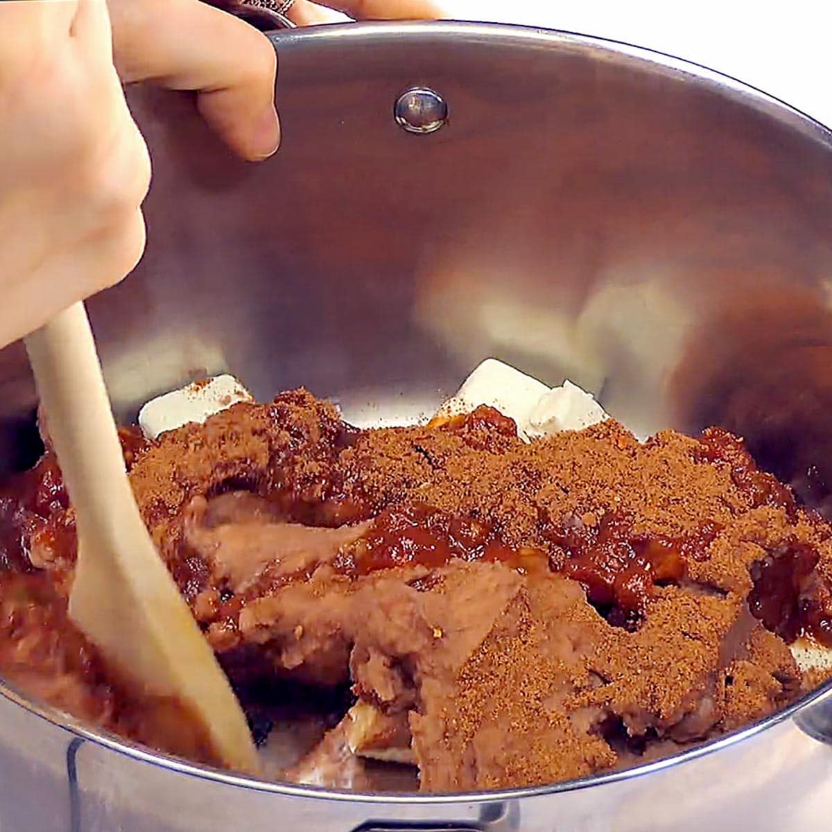Mixing Refried Bean Dip ingredients in pot.