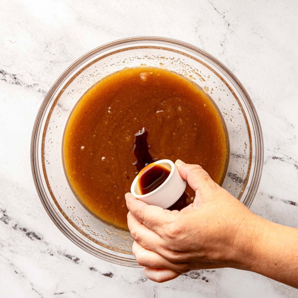 Adding vanilla to bowl.
