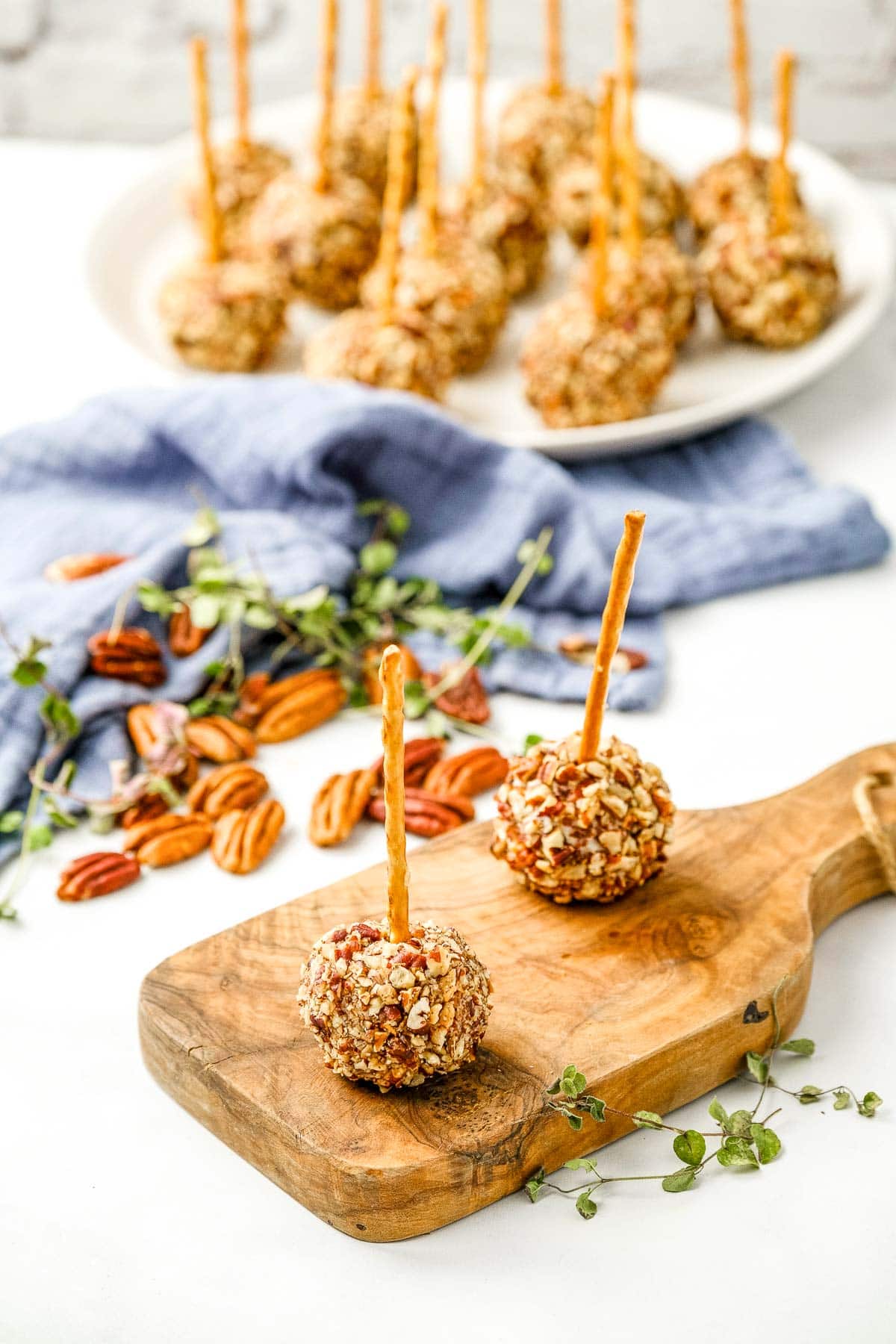 Mini Cheese Balls on wooden board and on plate.