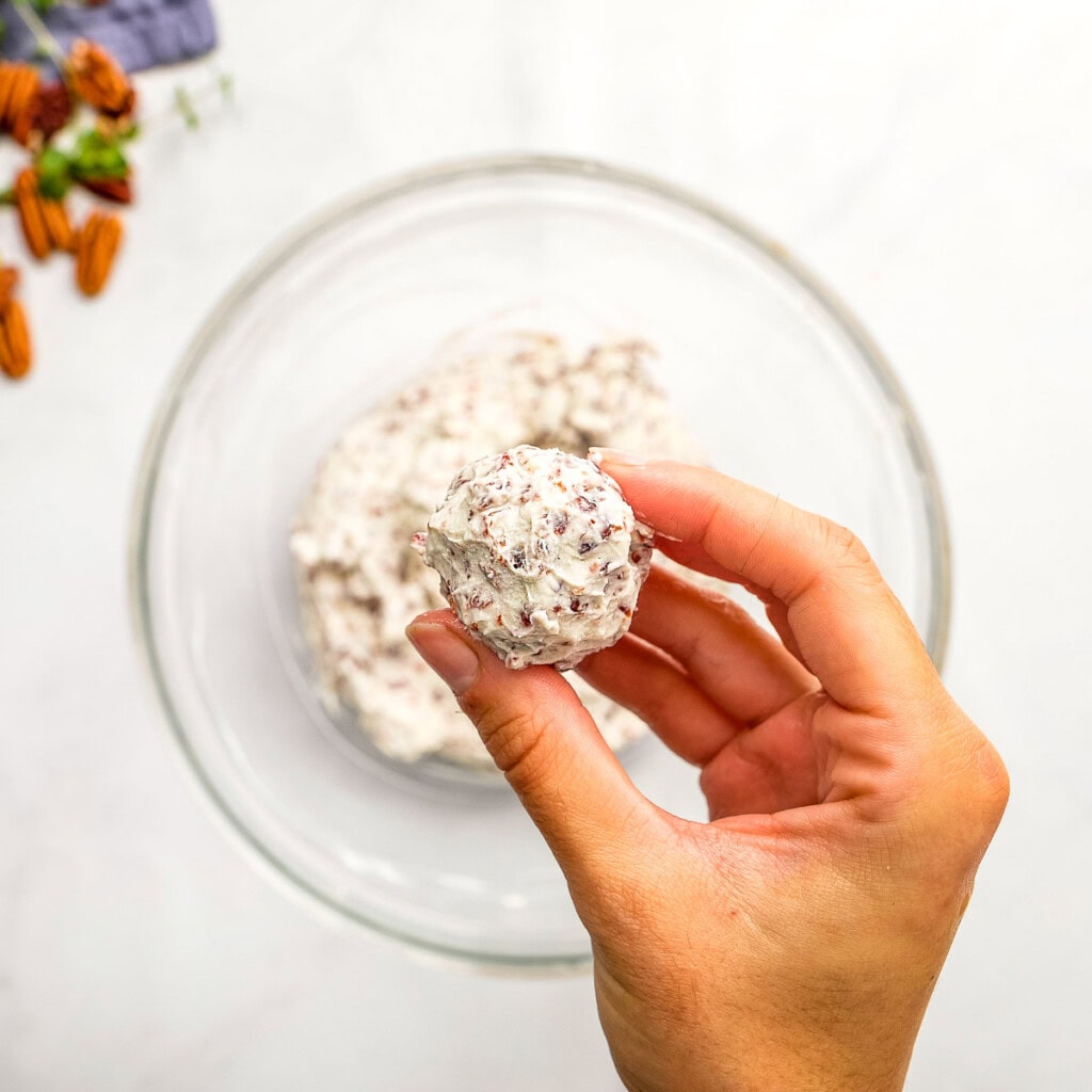 Forming Mini Cheese Balls with hands.