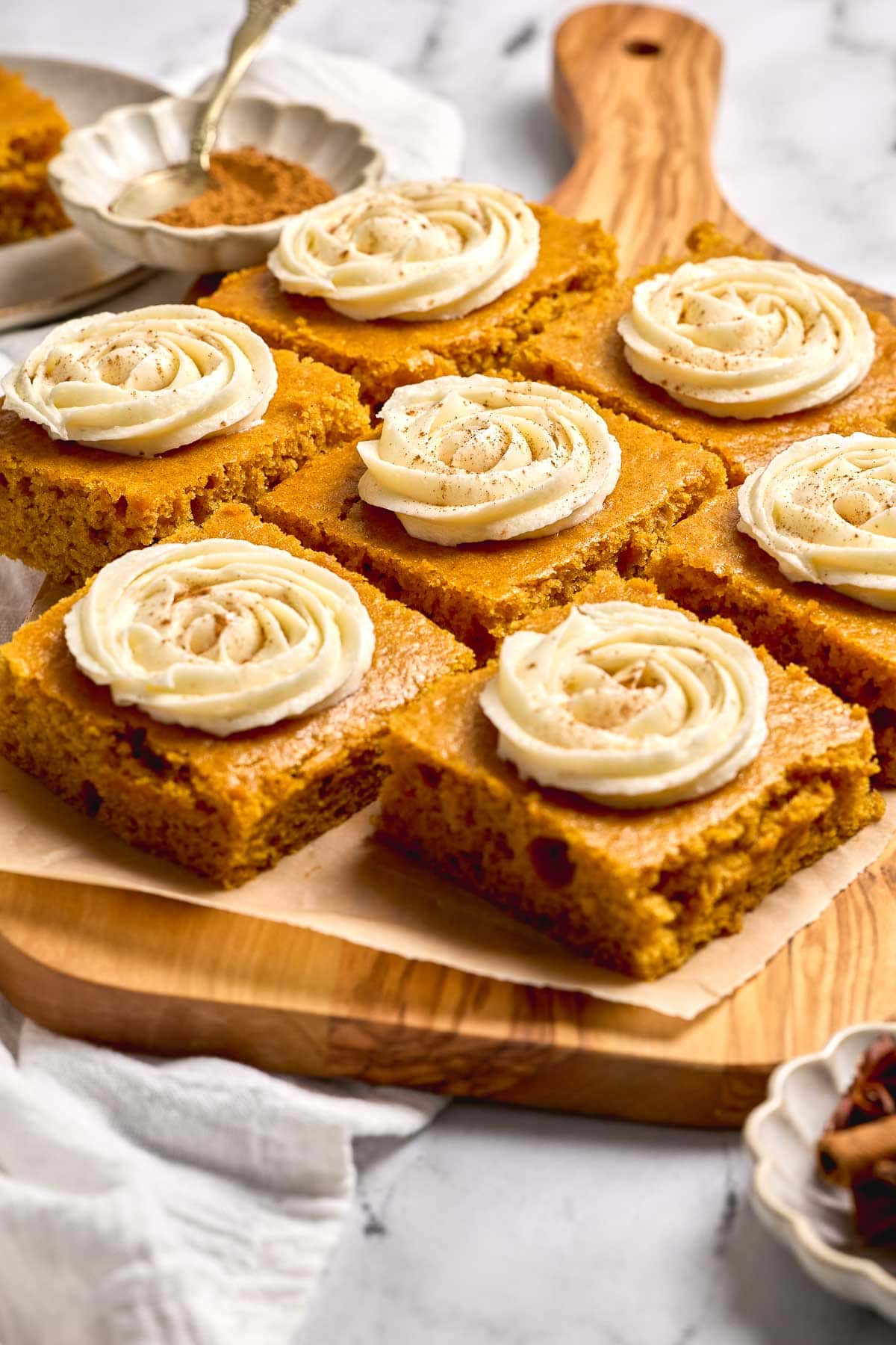 Pumpkin Bars with Cream Cheese Frosting in serving board.