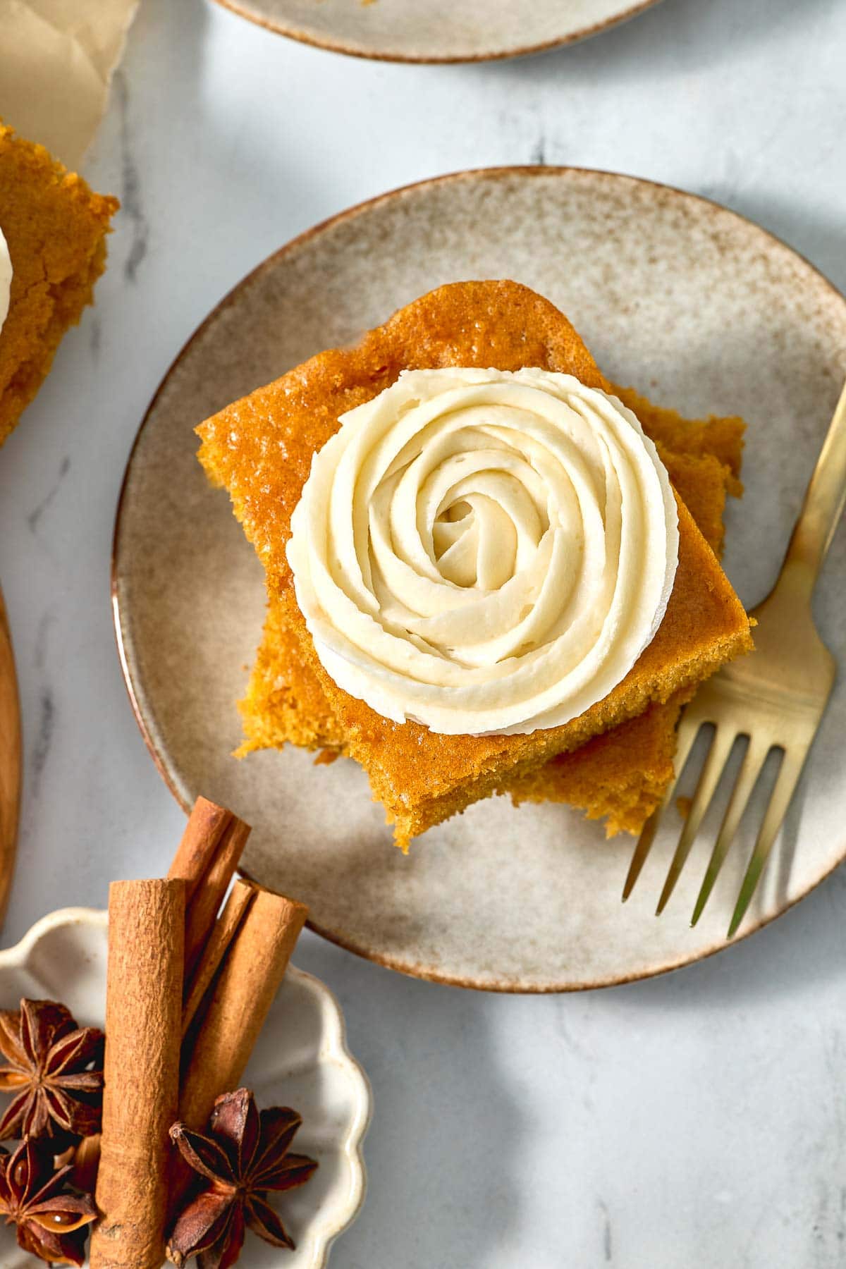 Pumpkin Bars with Cream Cheese Frosting aerial on plate with fork.