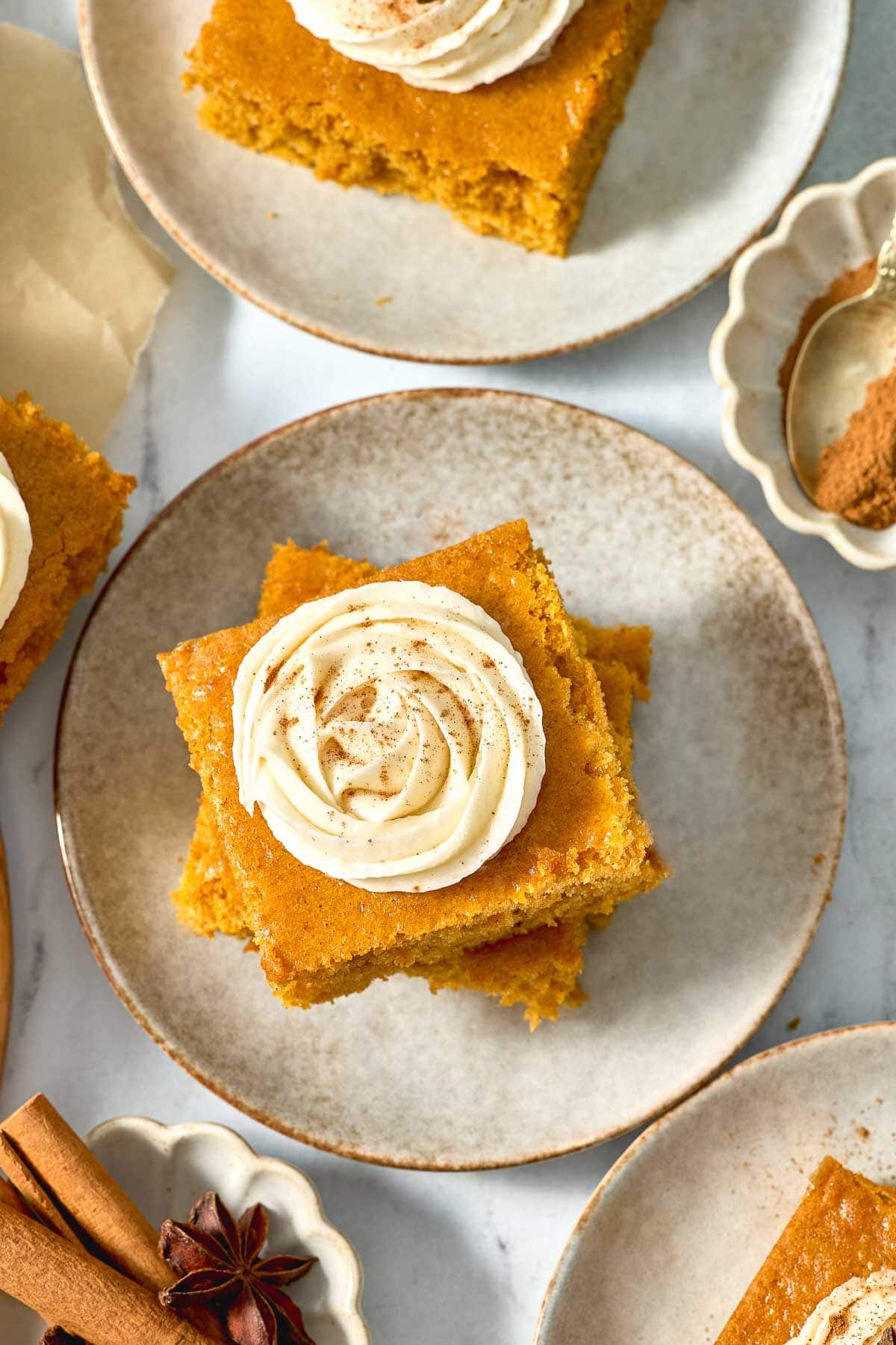 Pumpkin Bars with Cream Cheese Frosting aerial view on plates.