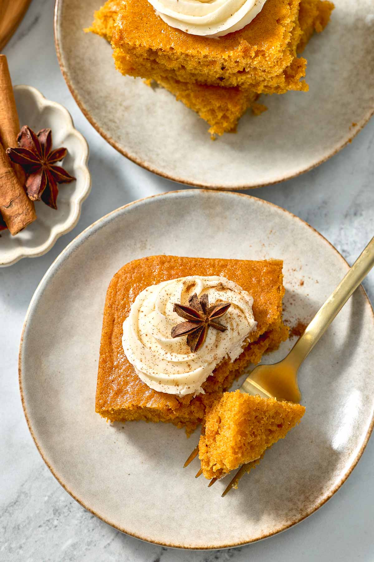 Pumpkin Bars with Cream Cheese Frosting with bite on fork.