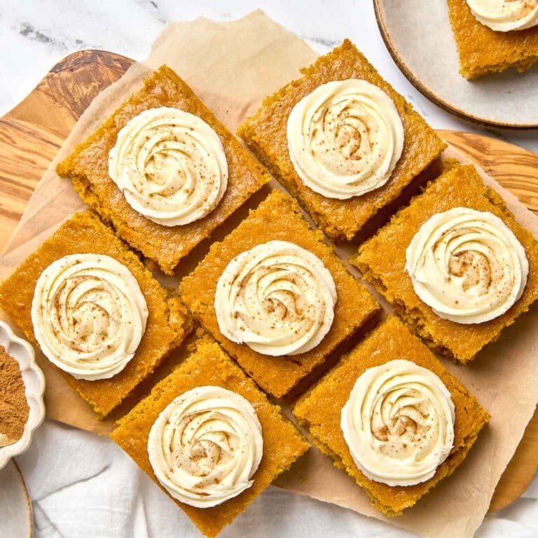 Pumpkin Bars with Cream Cheese Frosting on parchment paper aerial view.